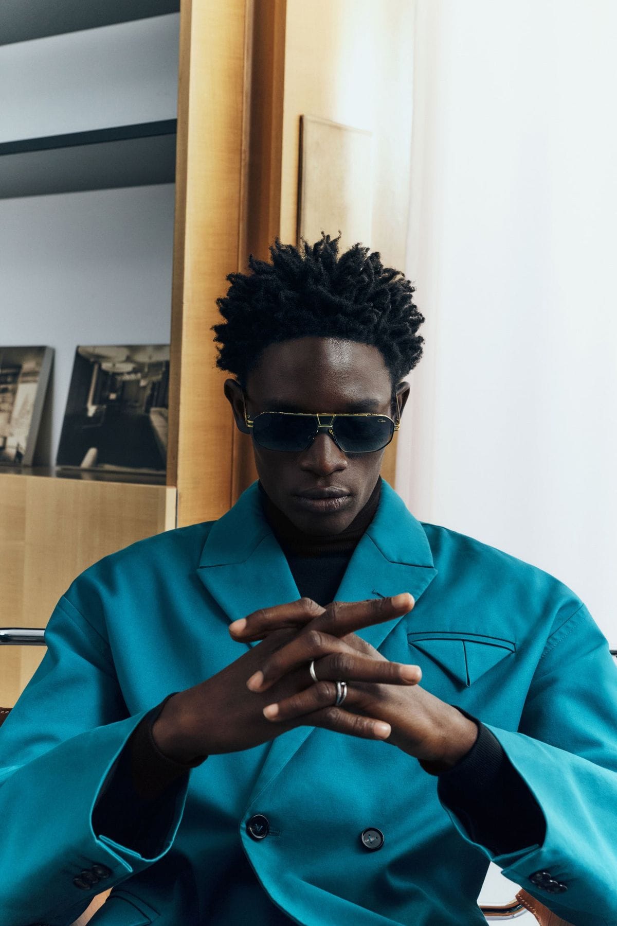 A man in a teal suit wearing Cazal MOD 9117 sunglasses