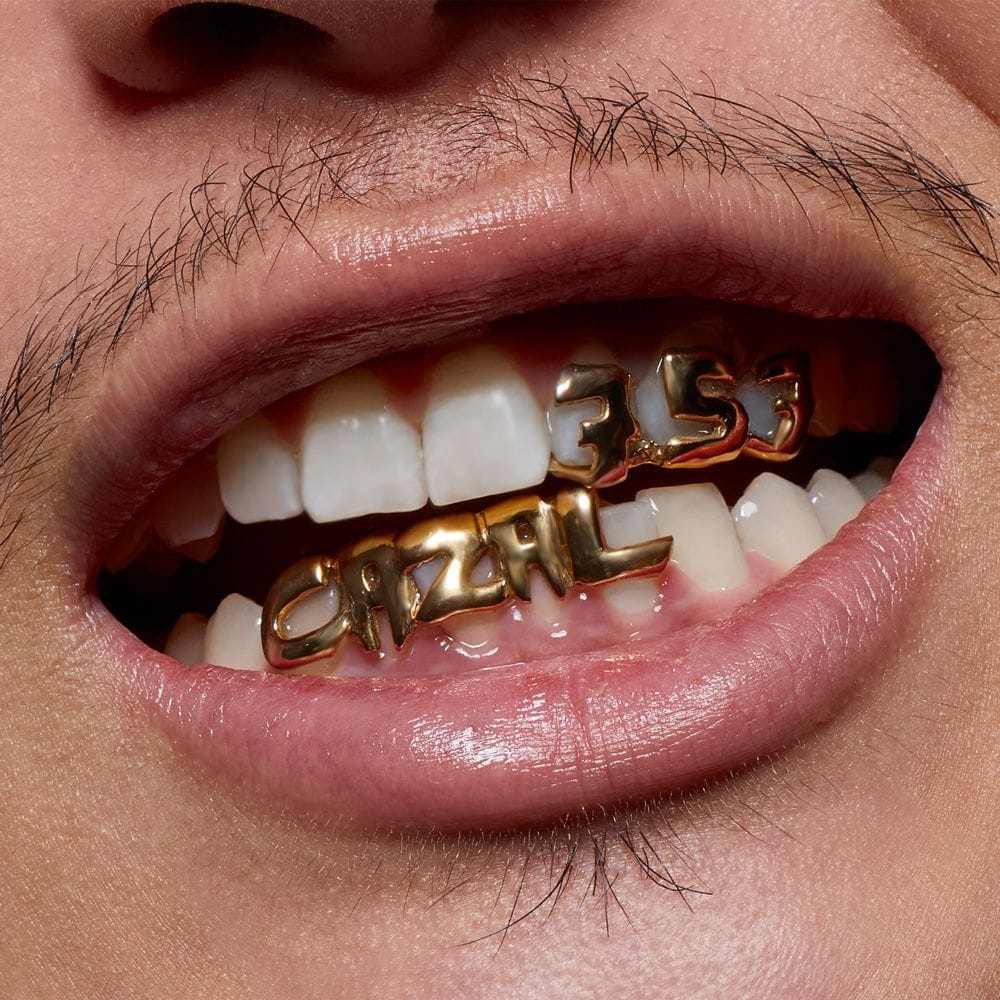 A gold grill spelling CAZAL