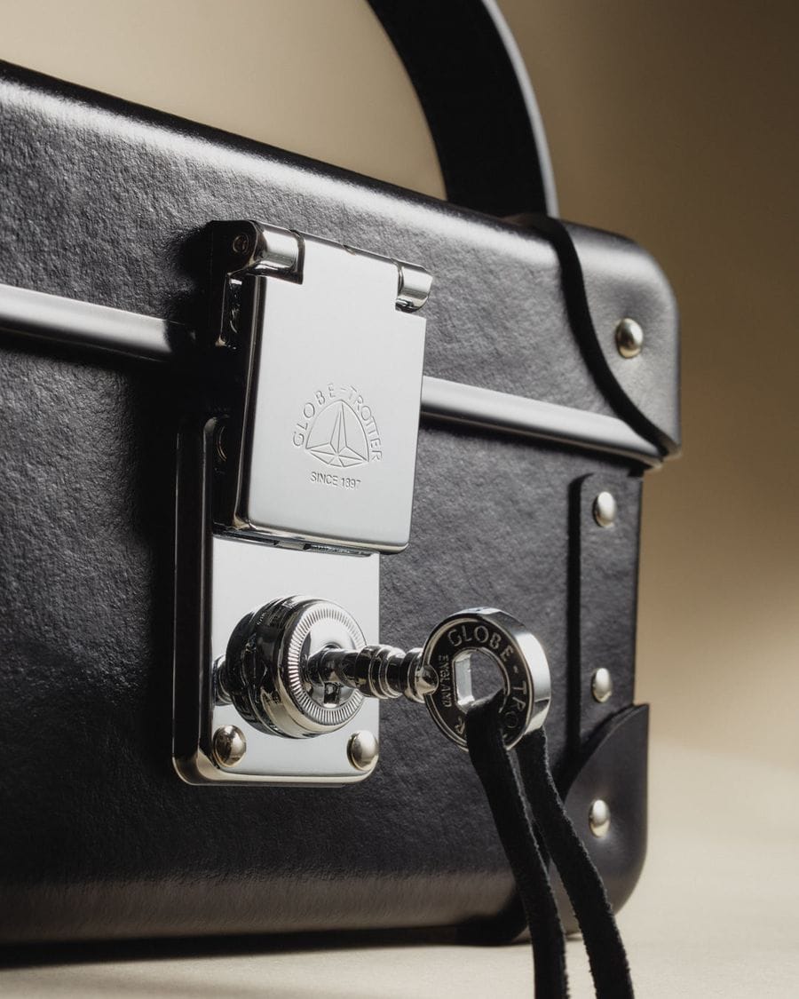 A black Globe-Trotter collector’s case with a polished lock