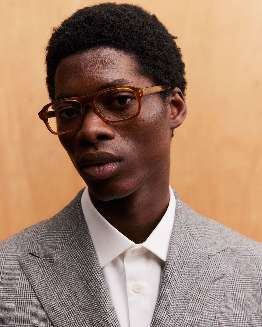 A man wearing tortoiseshell Kingsman aviator glasses