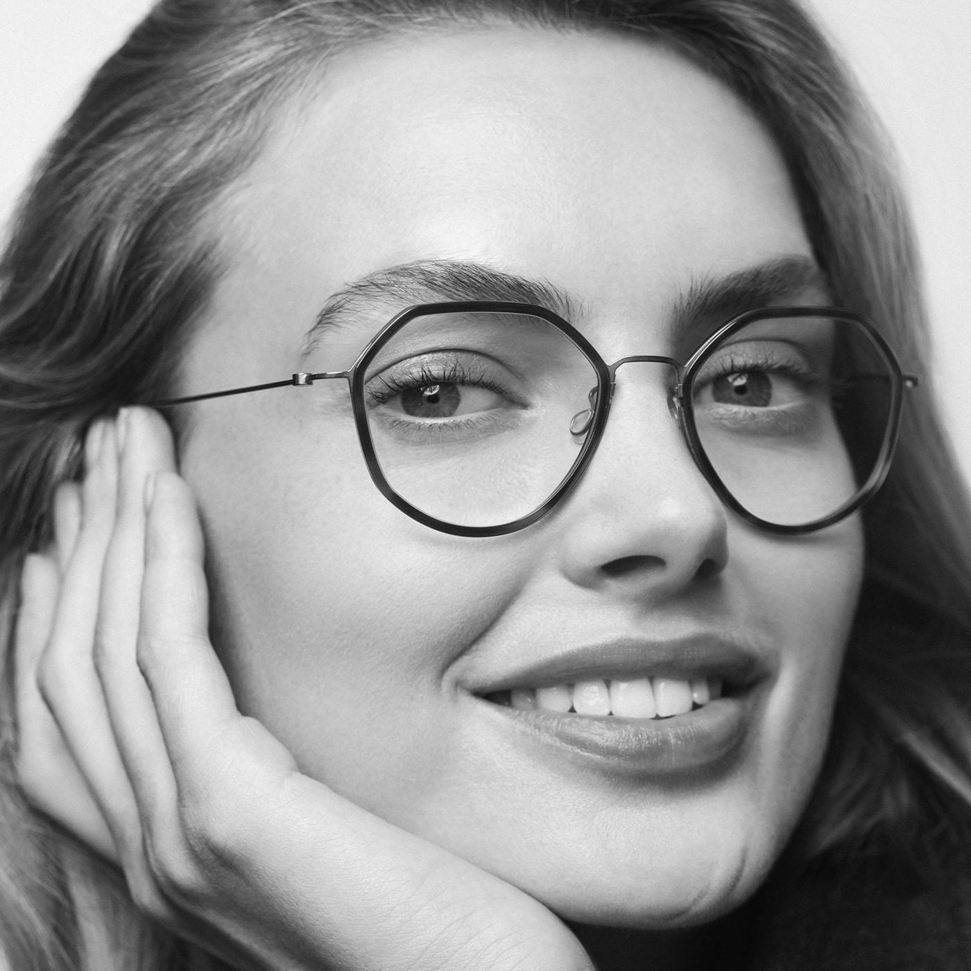 A woman wearing round LINDBERG thintanium glasses