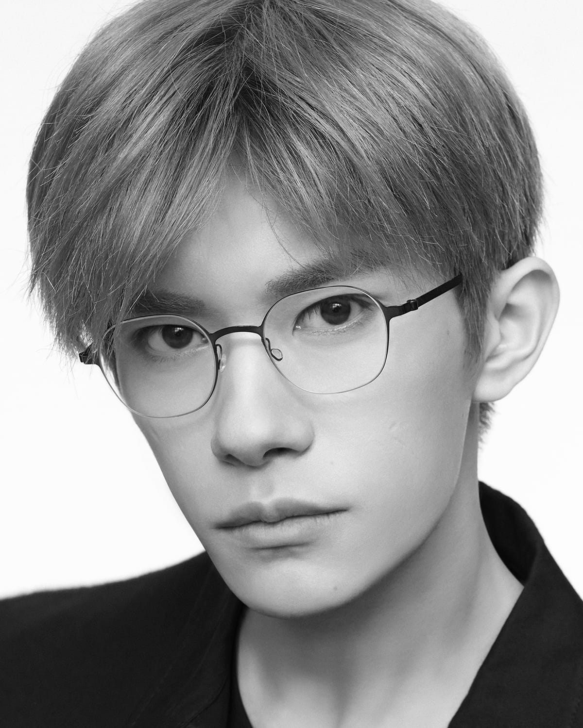 A young man wearing LINDBERG strip titanium glasses