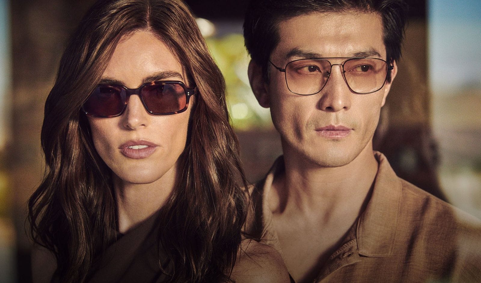 A woman in Oliver Peoples sunglasses and a man in Oliver Peoples glasses