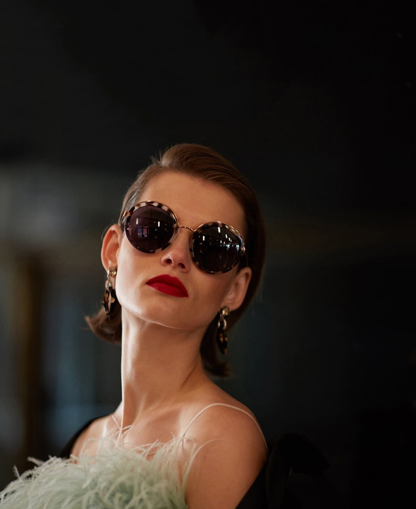A woman in dark Prada Cinema sunglasses