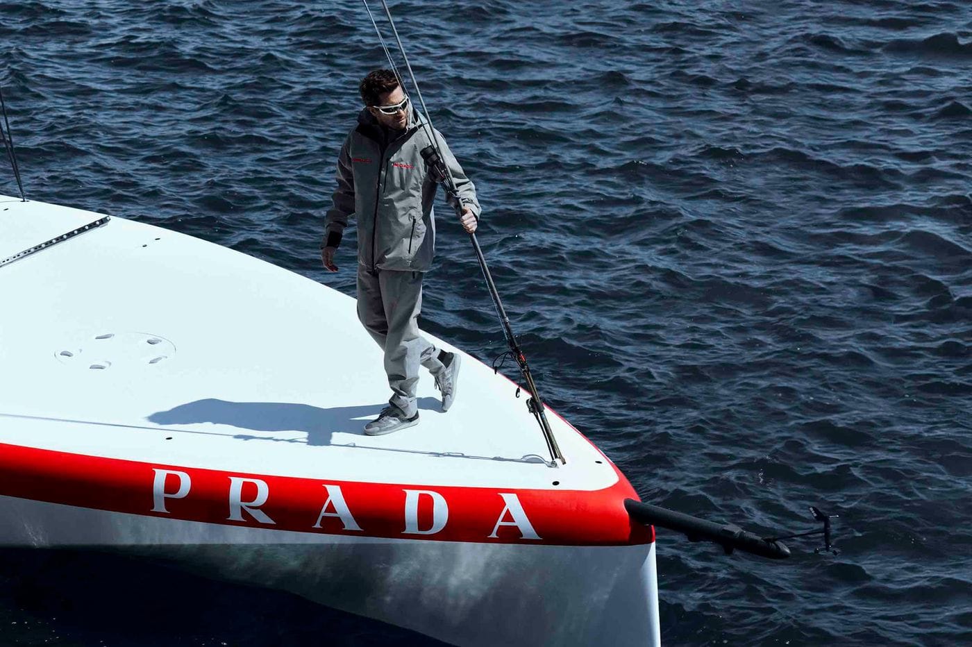 A figure on the bow of the Luna Rossa Prada Pirelli racing yacht