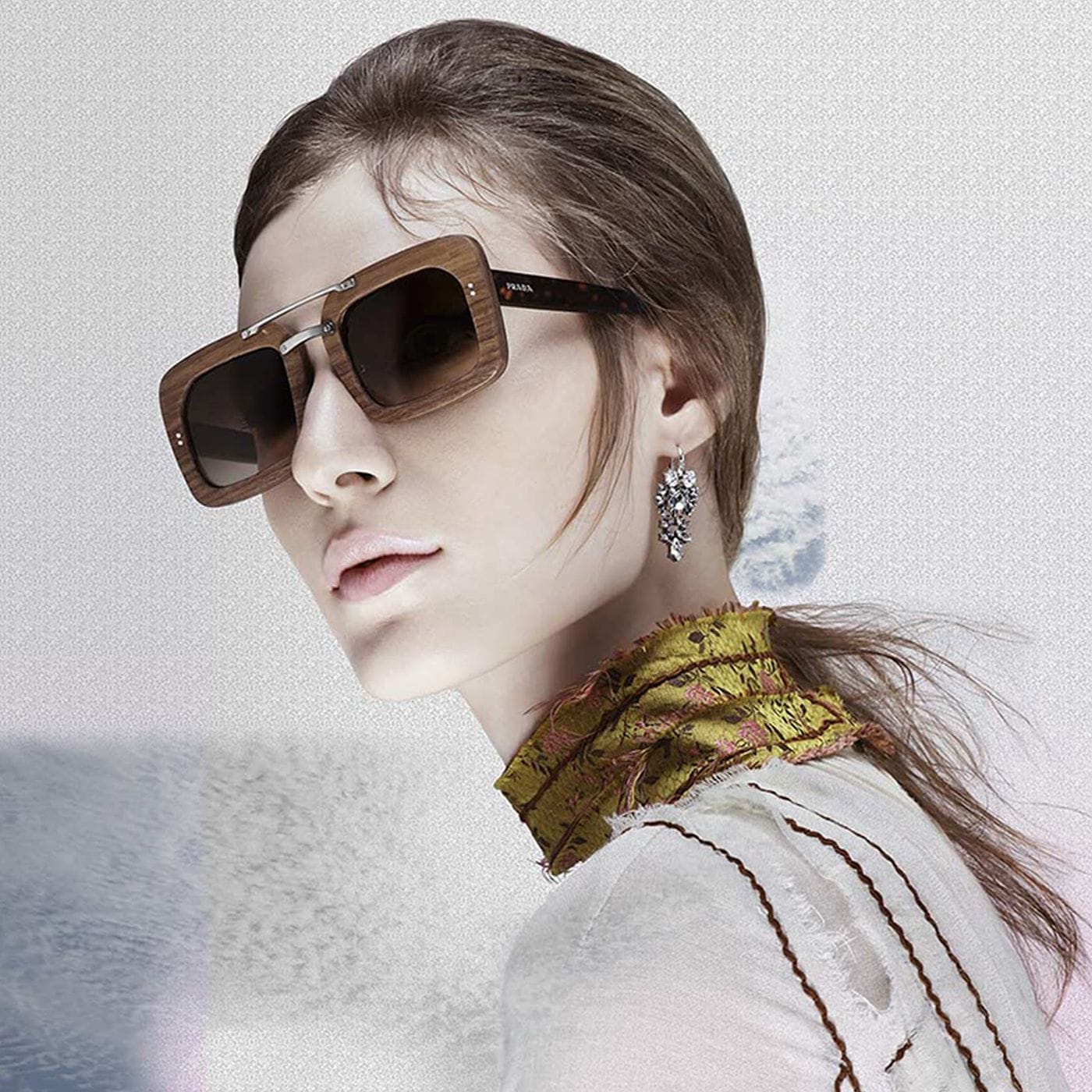 A woman wearing square Prada Raw glasses