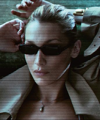 A woman in narrow black Saint Laurent sunglasses from the Spring-Summer 2026 campaign