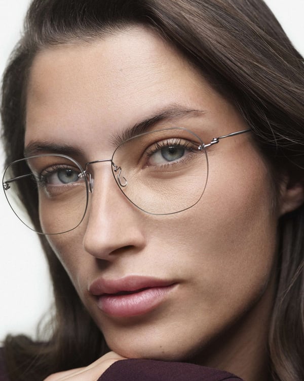 Woman wearing fine Lindberg rimless titanium glasses