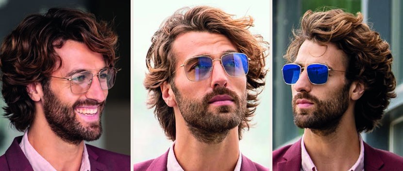 A bearded man in Sensity Shine glasses, the lenses showing a light mirror finish