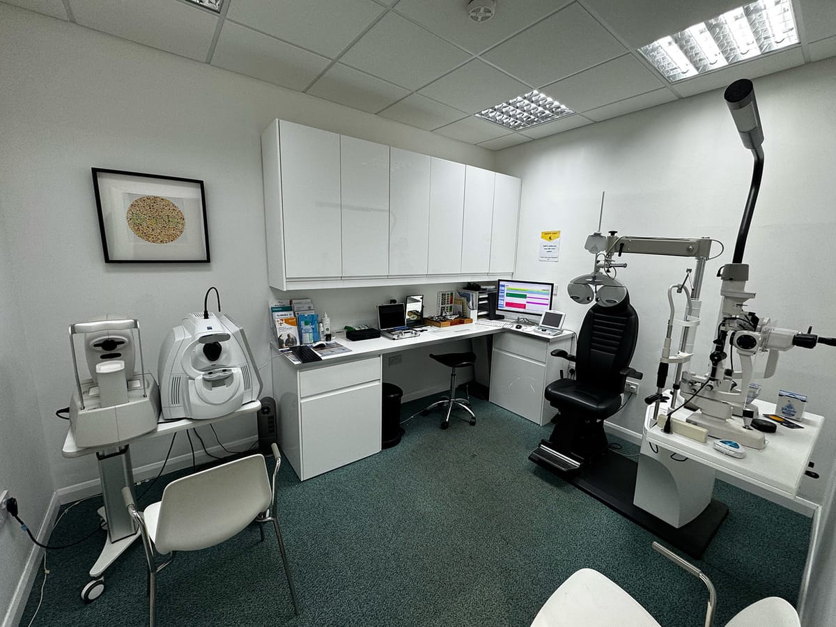 The eye examination room at EYE Opticians Barnt Green, with OCT scanner and slit lamp